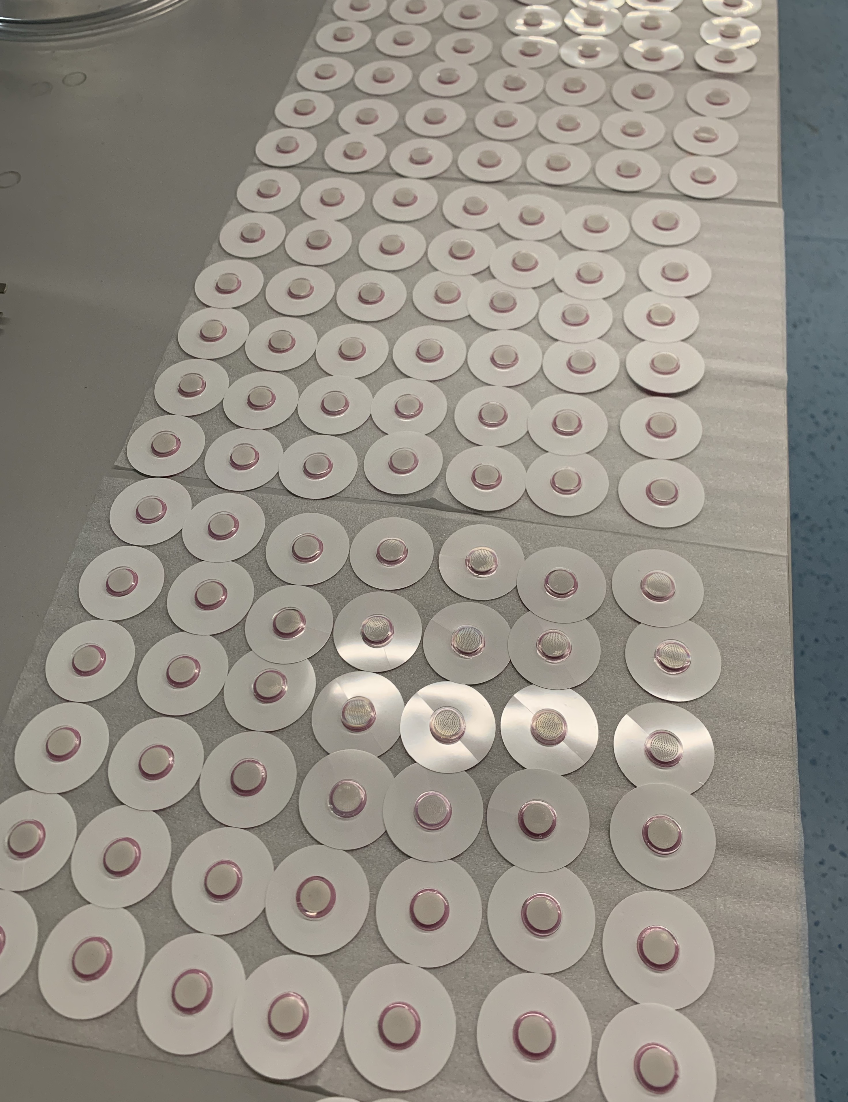 In-process circular patch components arranged for production handling